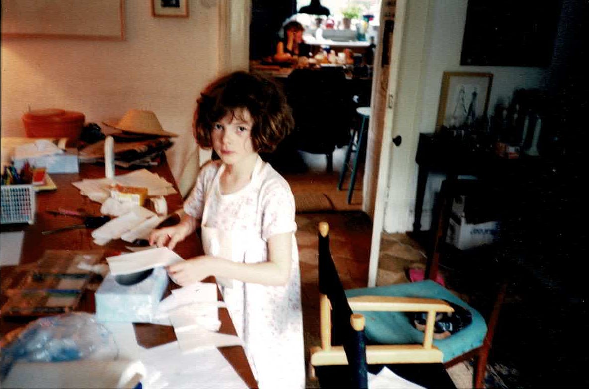 Image Description - A photo of me as a child making something from bits of paper and tissue, taking it very seriously it seems, which is usually a sign that I’m actually really enjoying it. 