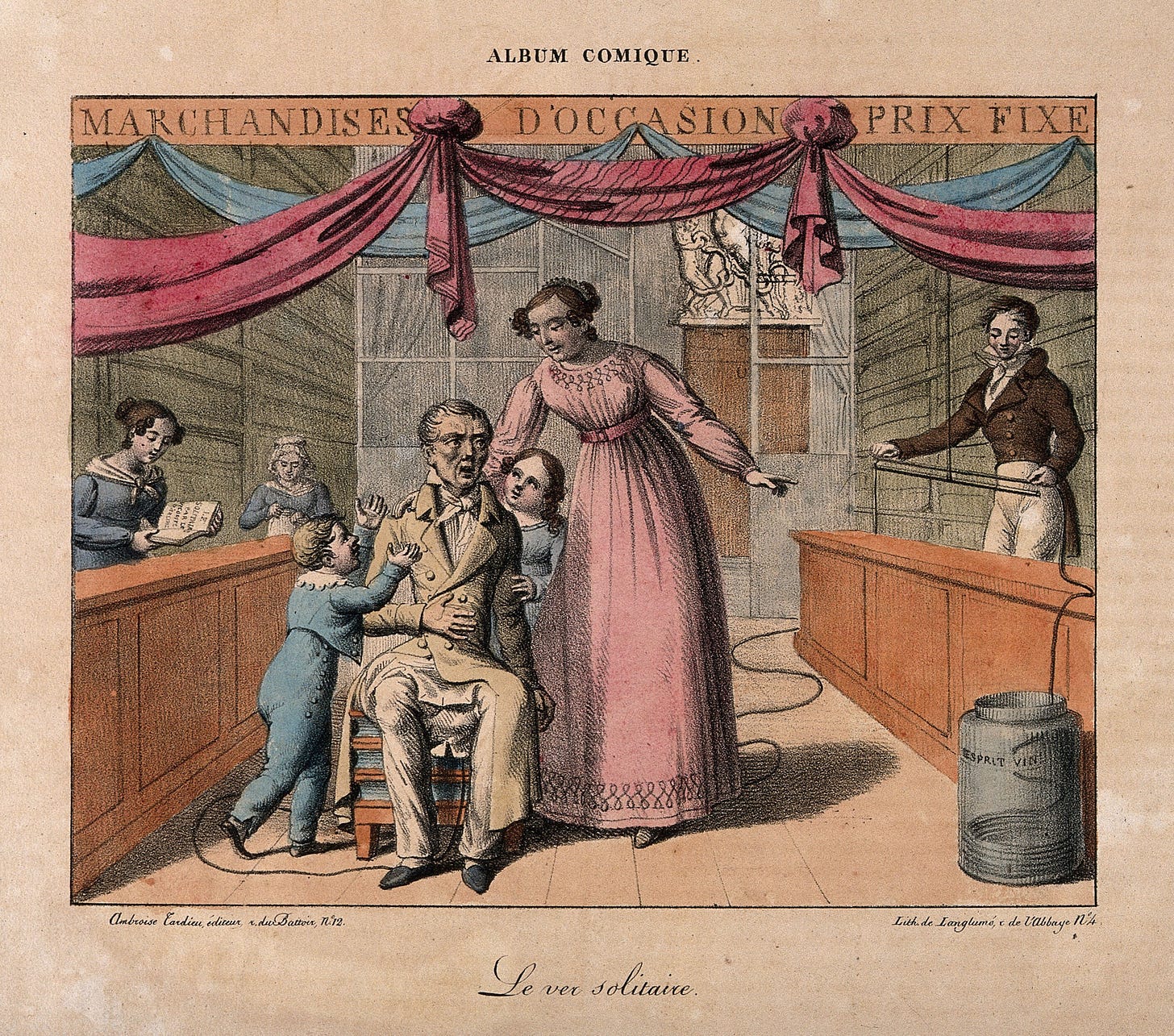 A 19thC lithograph showing a sick-looking man sitting on a commode. He is being pestered by two children, and a woman stands nearby, talking to him and pointing towards another man on the right of the image. This man is using a long ruler to measure sections of a tapeworm that originates in the region of the commode – the implication being that it is coming from the patient’s bottom. Once measured, the tapeworm is being coiled into a large jar of spirits on the floor. 