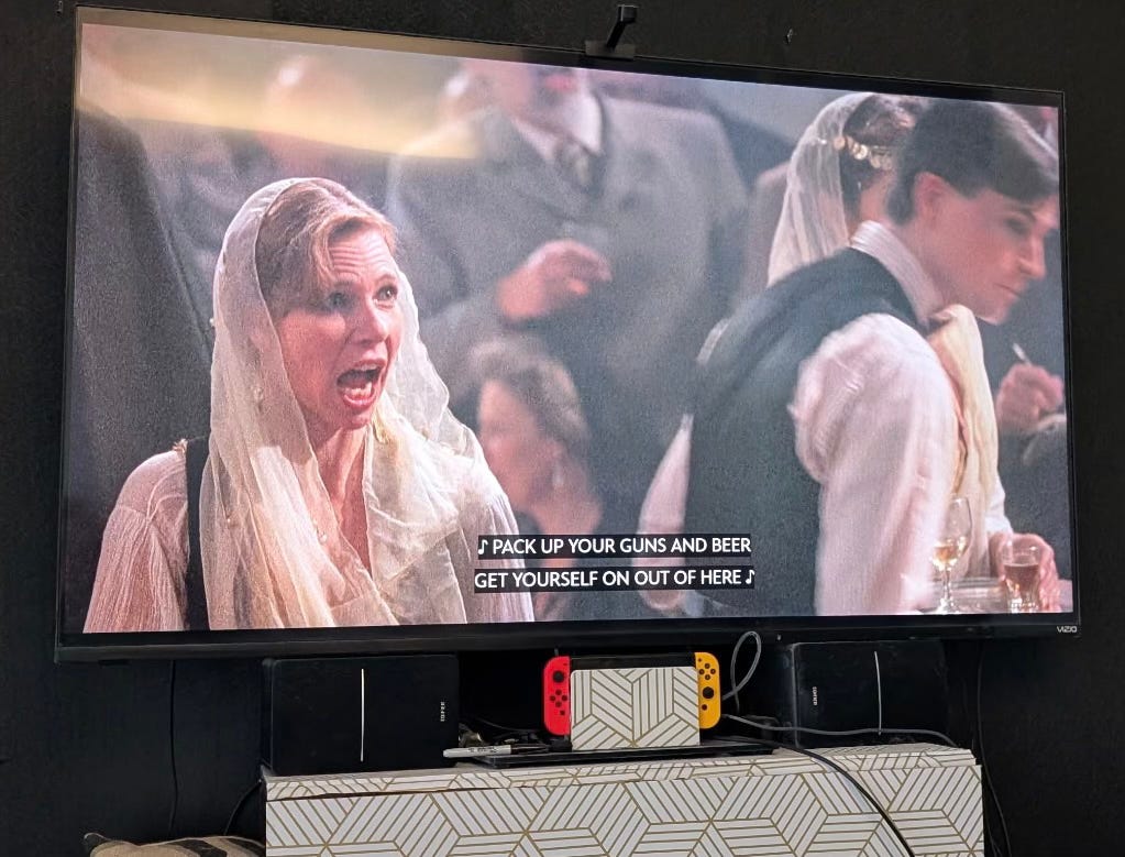 A dancer in a white veil sings "Pack up your guns and get yourself on out of here!"