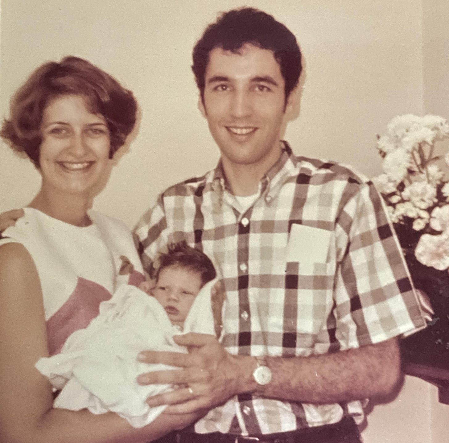 My young parents holding a baby -- me