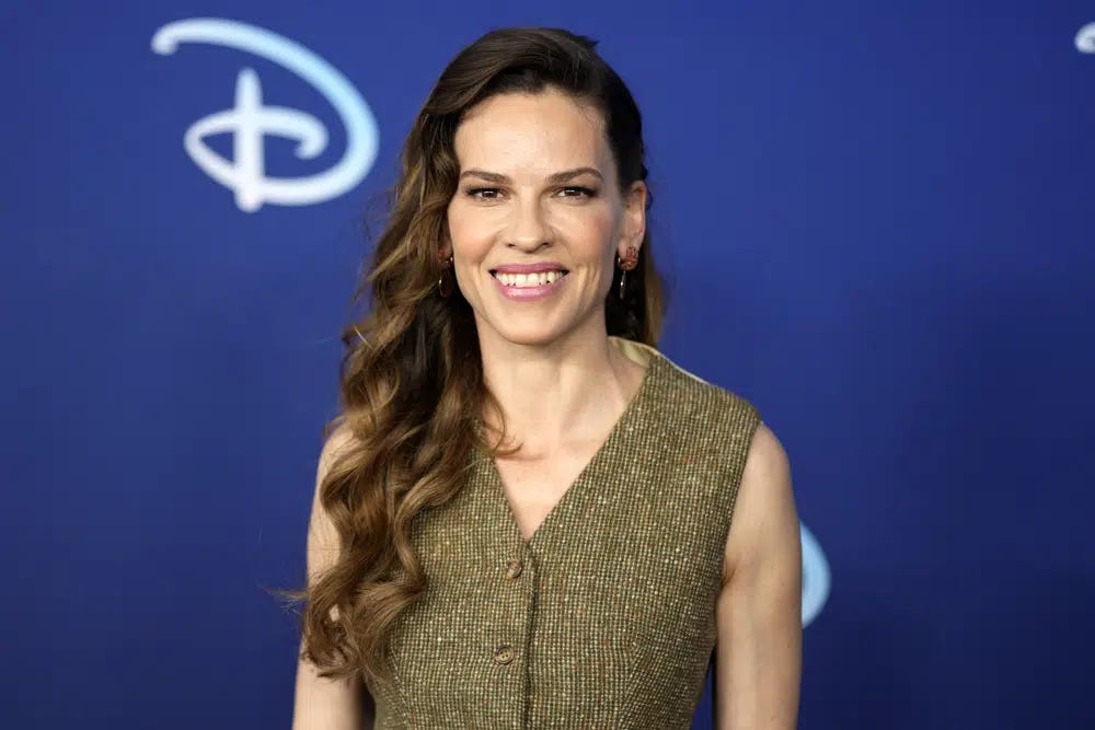 FILE - Hilary Swank attends the Disney 2022 Upfront presentation at Basketball City Pier 36 on Tuesday, May 17, 2022, in New York. Swank has given birth to twins — a boy and a girl. The 48-year-old “Million Dollar Baby” actor posted a photo of her and her twins looking at the sunset on Instagram Sunday. (Photo by Charles Sykes/Invision/AP, File)