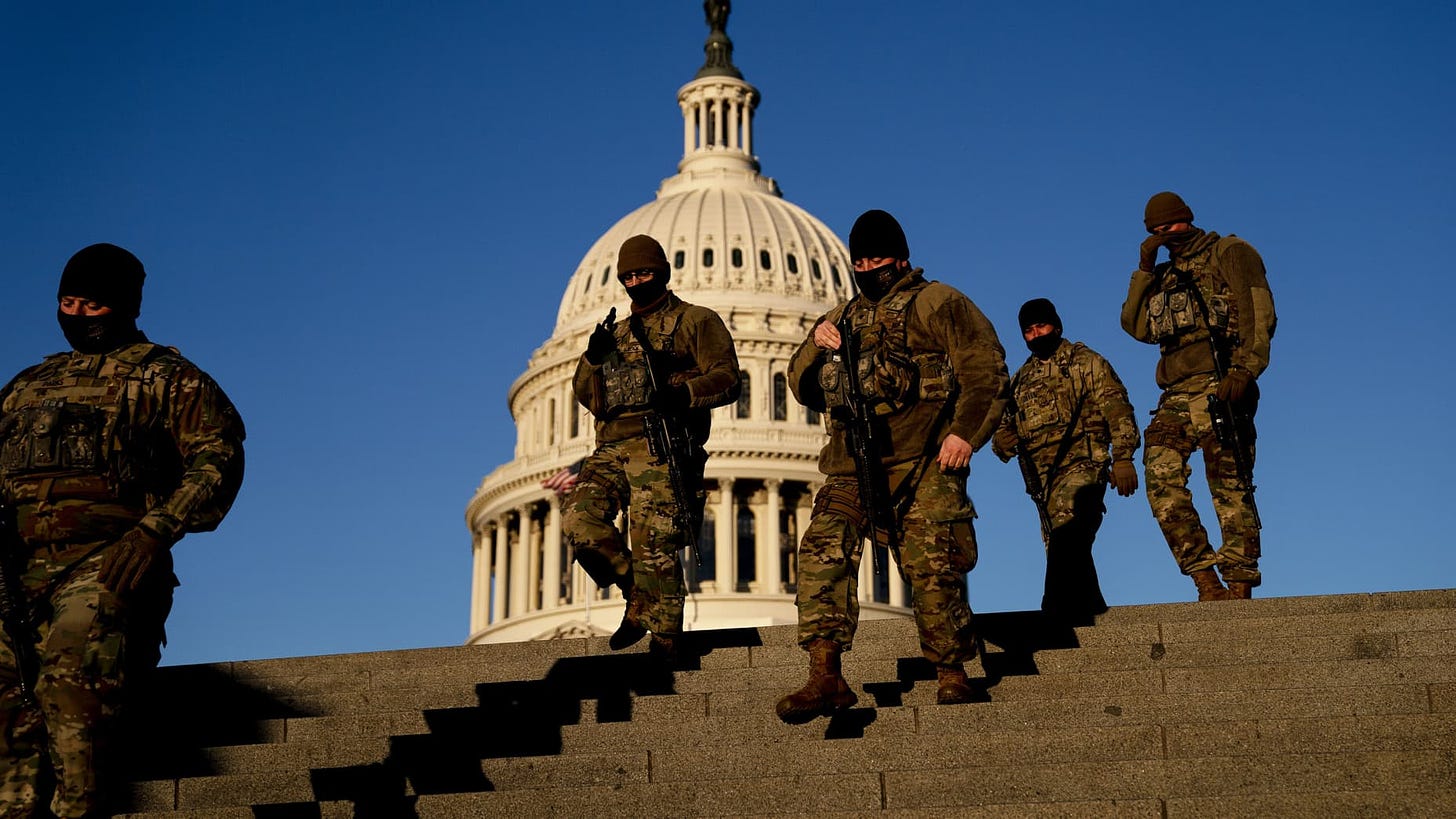 Members of the National Guard walk outside the U.S. Capitol in Washington, D.C., on Friday, March 5, 2021.