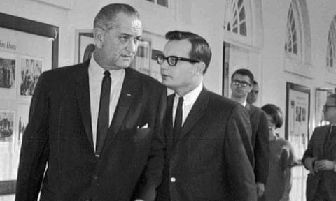 Lyndon Johnson listens to his press secretary, Bill Moyers, in January 1966.