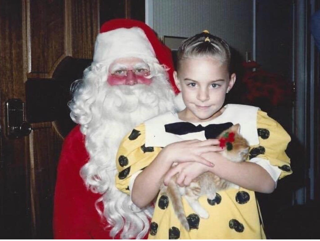 Santa and young girl with orange tabby