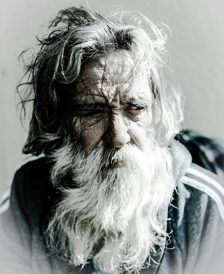 Elderly man with white hair and white beard.