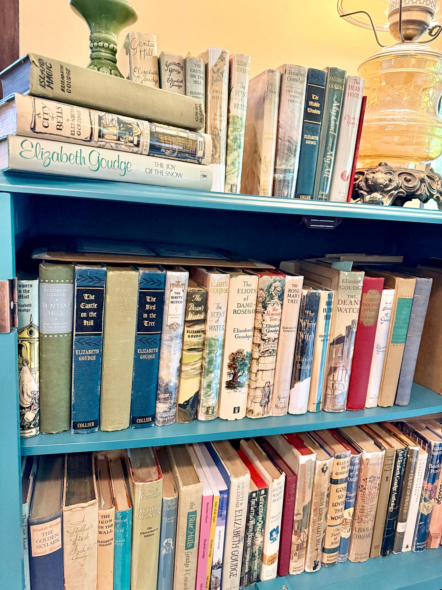 My Goudge bookcase with our 2025 reads on top, her adult fiction on the top shelf, and her short stories, children's books, and anthologies on the bottom shelf. My Goudge bookcase with our 2025 reads on top, her adult fiction on the top shelf, and her short stories, children's books, and anthologies on the bottom shelf.