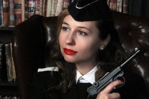 Female military officer in WW2 costume with handgun