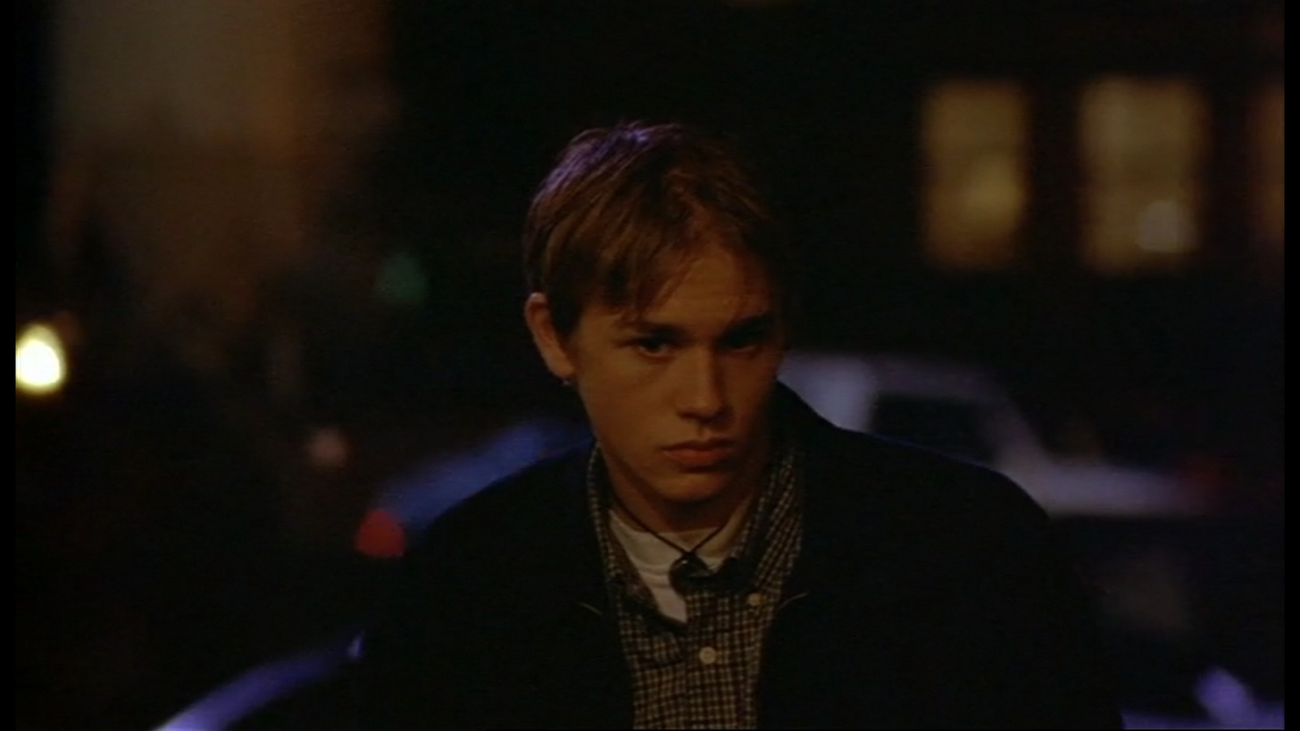 Charlie Hunnam as Nathan Maloney, standing in the foreground of a blurred Canal Street at night