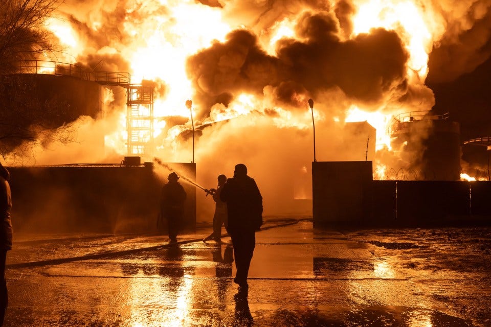 Firefighters battling a large industrial fire.