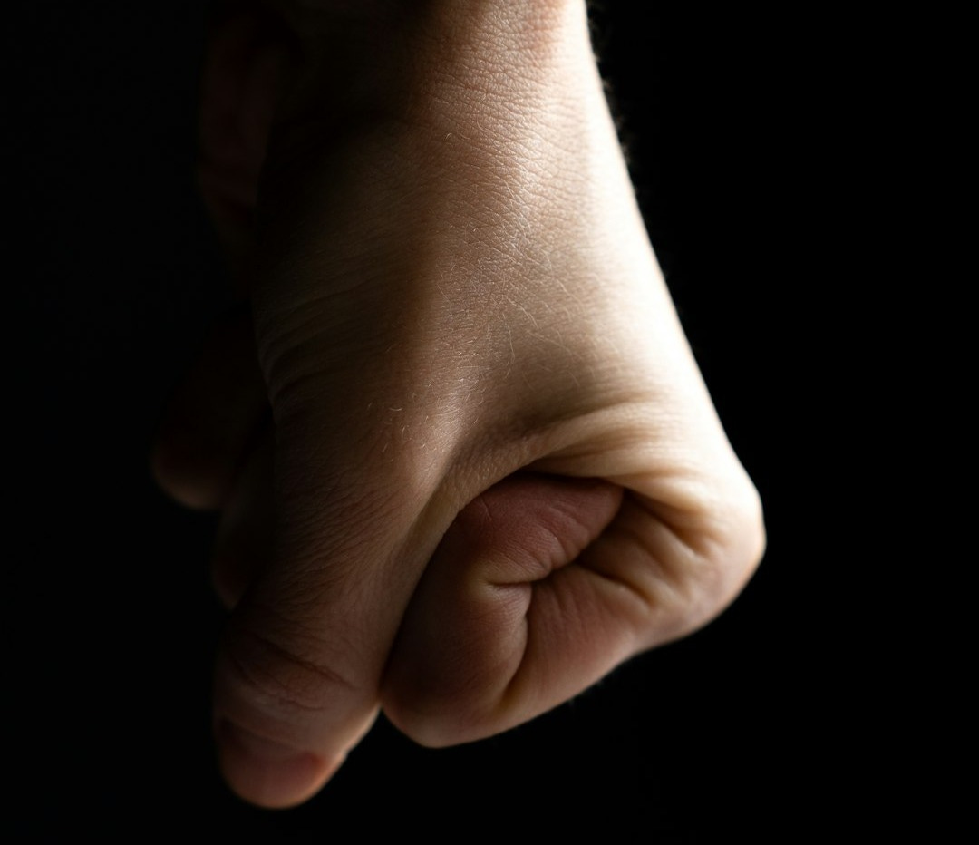 a close up of a person's hand on a black background