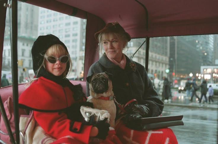 This may contain: two women sitting on a bus with a dog