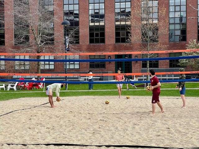 A group of people playing volleyball

Description automatically generated