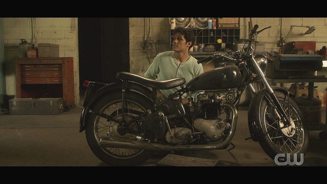 Drake Rodger working on motorcycle.