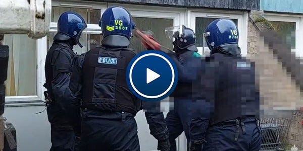 Video: Police officers in specialist protective uniform using force to enter a house