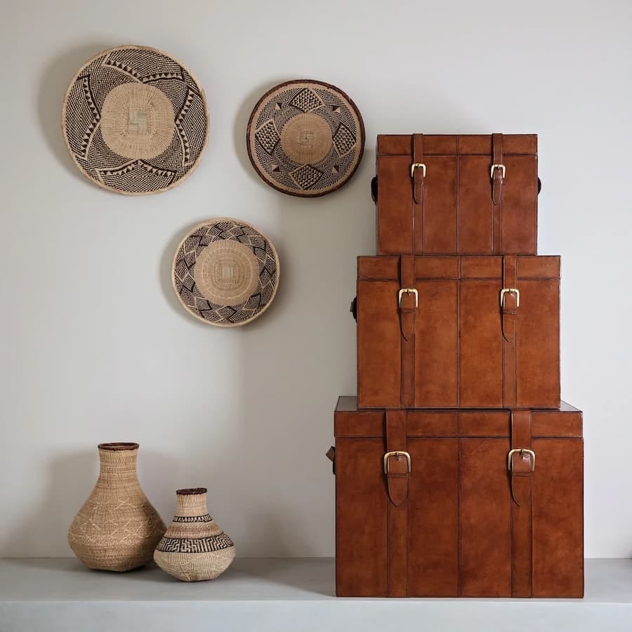 Set of three leather storage trunks in small, medium and large