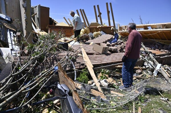 Doris Hensley, center, and Don Allen look over the remains of her home following severe weather in London, Ky., Saturday, May 17, 2025. (AP Photo/Timothy D. Easley) Doris Hensley, center, and Don Allen look over the remains of her home following severe weather in London, Ky., Saturday, May 17, 2025. (AP Photo/Timothy D. Easley)
