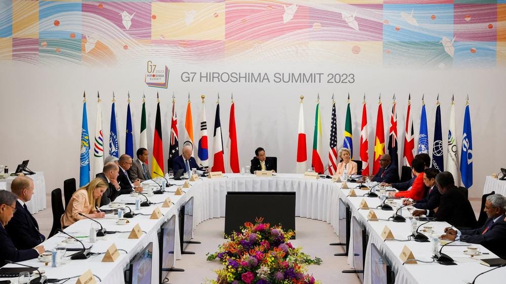 Canada's Prime Minister Justin Trudeau, Japan's Prime Minister Fumio Kishida, U.S. President Joe Biden, Germany's Chancellor Olaf Scholz, Indonesia's President Joko Widodo, Italy's Prime Minister Giorgia Meloni, Citigroup's CEO Jane Fraser and European Commission President Ursula confer during the 2023 G7 summit in Hiroshima, Japan