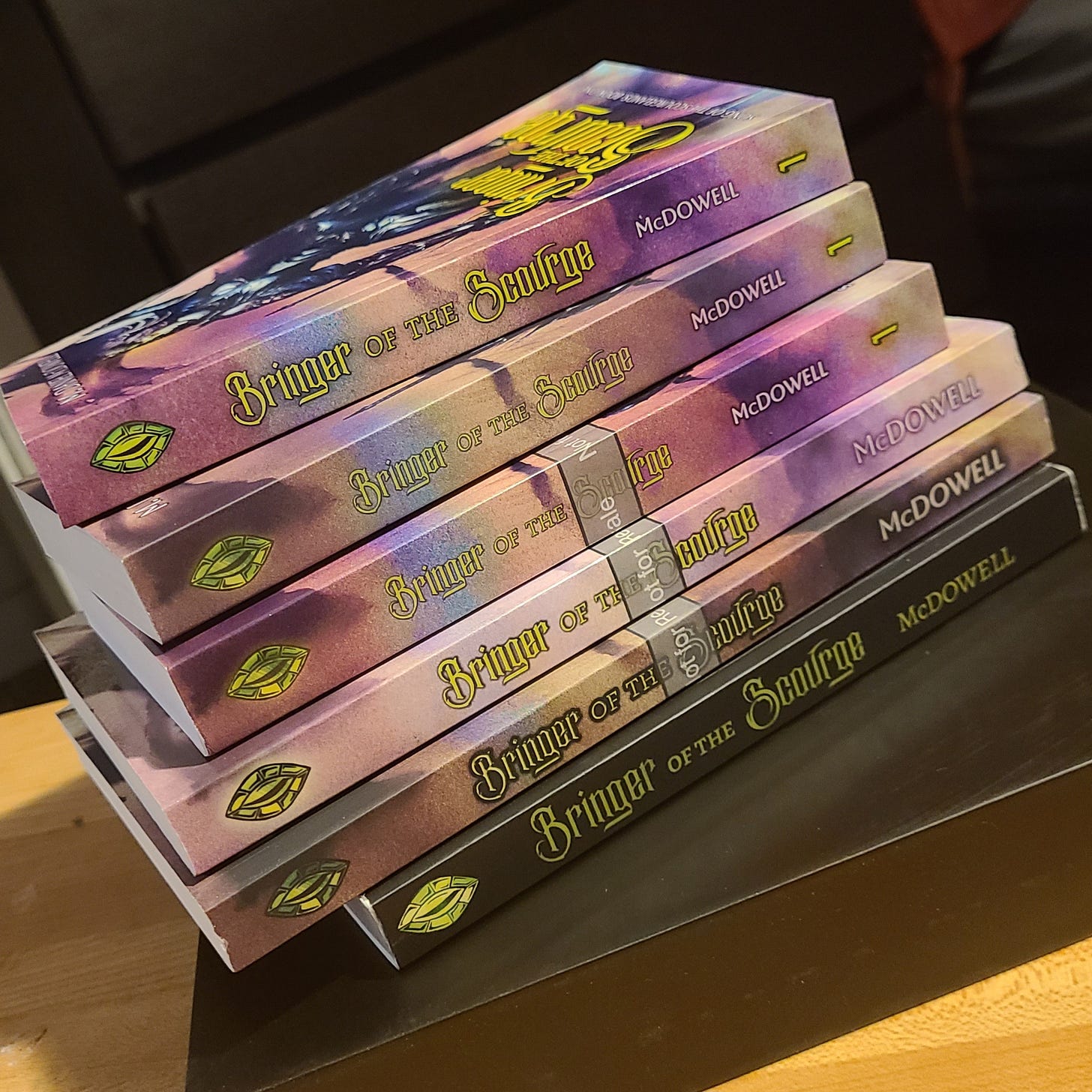 A stack of six different copies of Bringer of the Scourge, five of them proofs and one final. 
