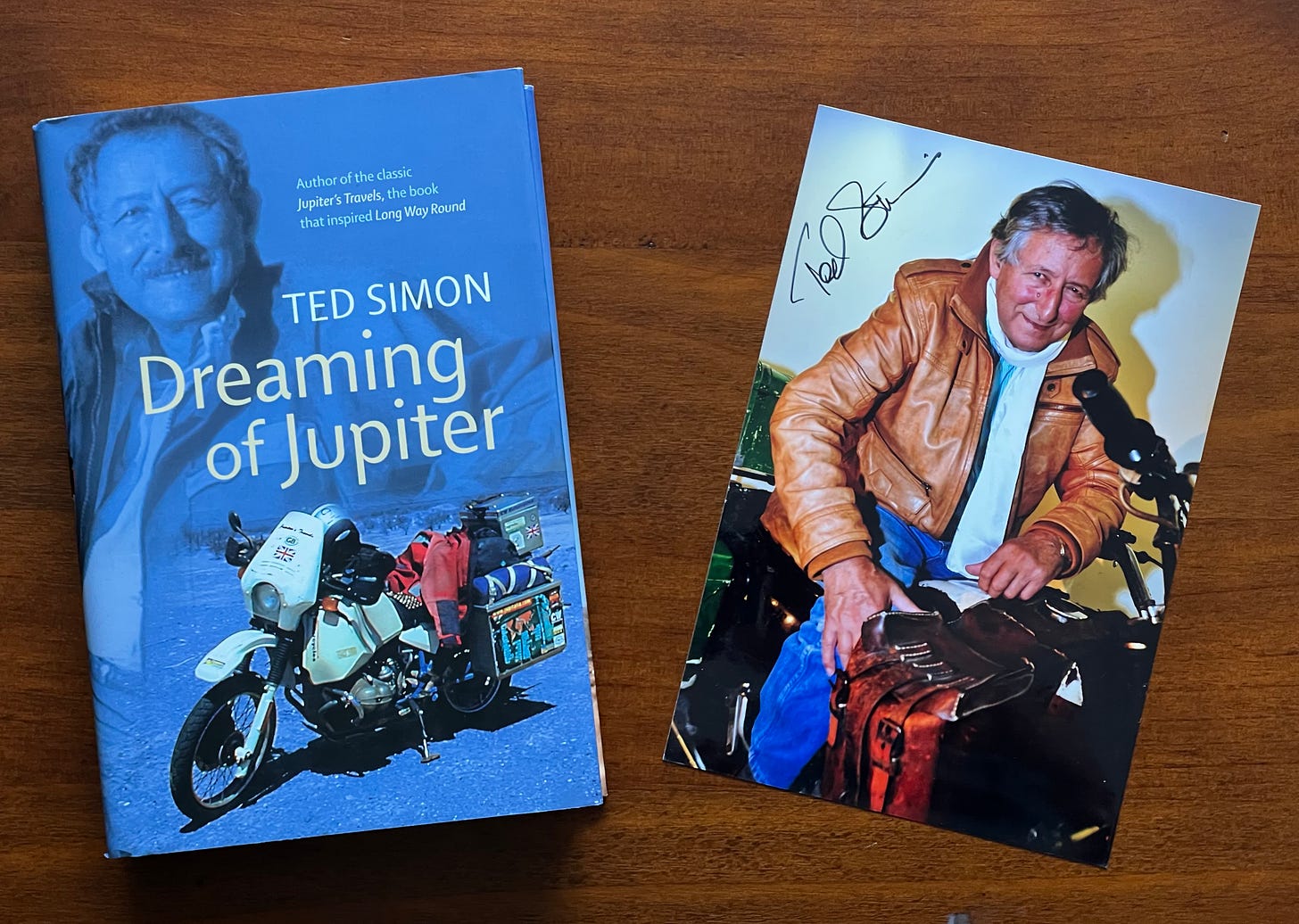 A photograph of Ted Simon's book dreaming of Jupiter. Next to it sits a signed photograph of Ted Simon. It was found in the book.