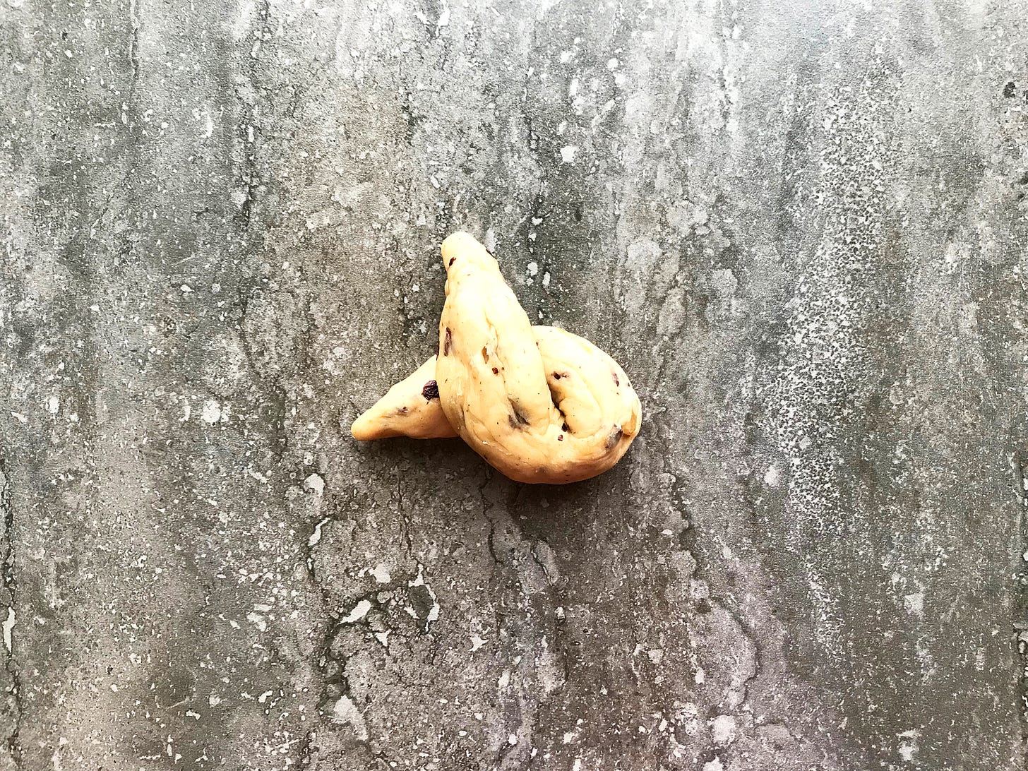 A twist of currant- and mixed peel-speckled hot cross bun dough. The ends are the ears and the loop is the face.
