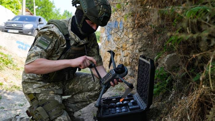 A Ukrainian serviceman holding a DJI drone