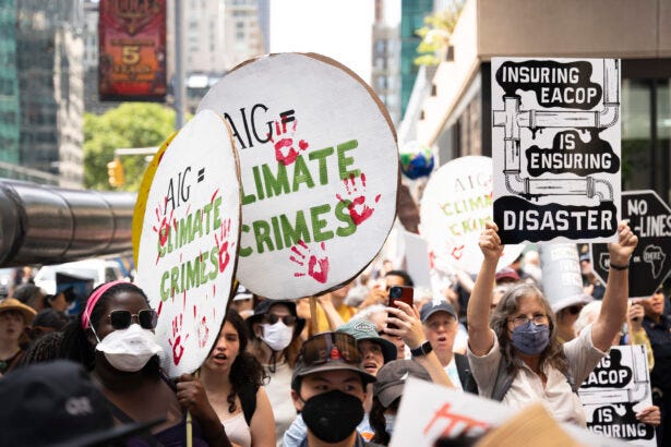 Protesters target AIG for insuring the fossil fuel industry