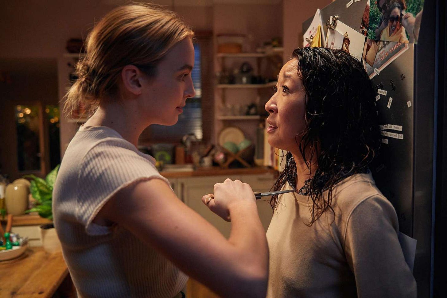Villanelle holds a knife to Eve's neck in Eve's kitchen