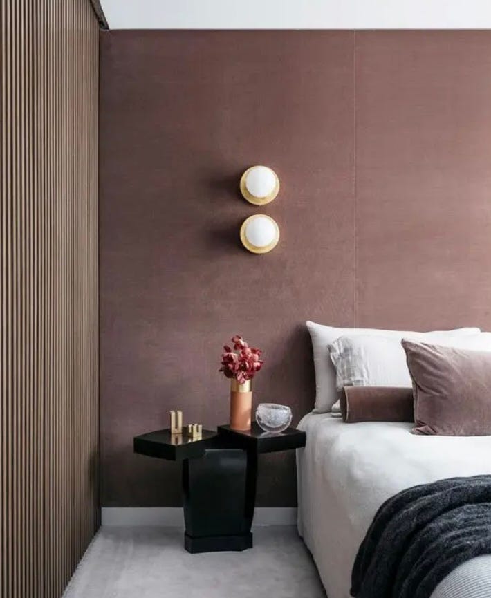 dusky rose painted bedroom wall with slat wall