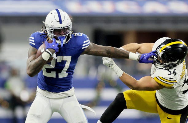 Trey Sermon of the Indianapolis Colts stiff arms Alex Highsmith of the Pittsburgh Steelers during the fourth quarter at Lucas Oil Stadium on December...