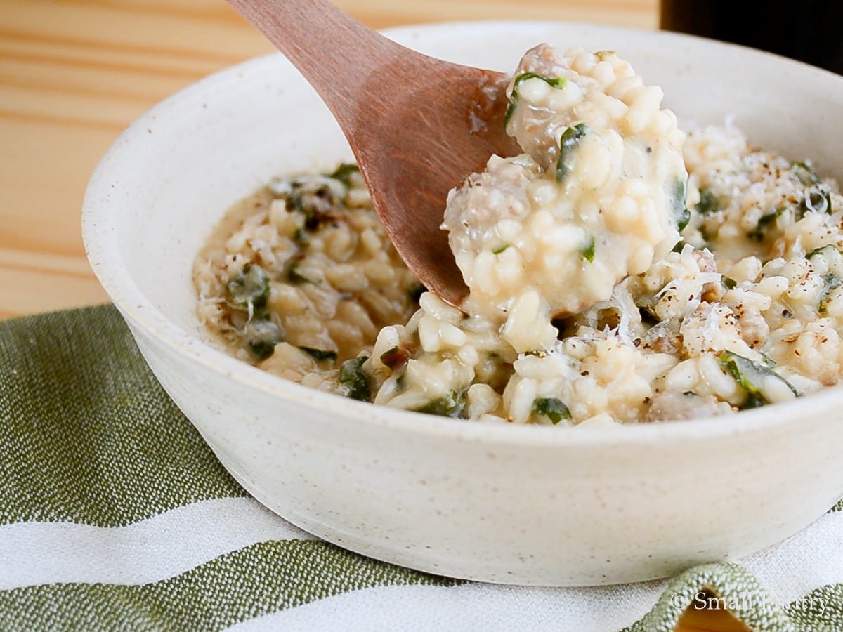 A spoonful of sausage risotto with greens