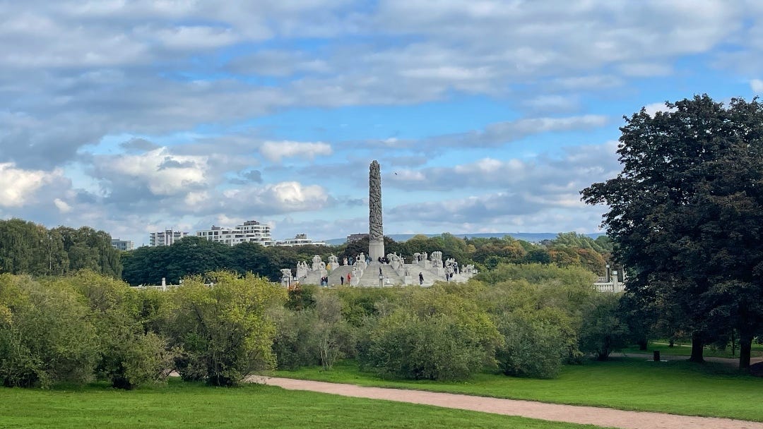 view at the central sculptures in the park with the city in the back