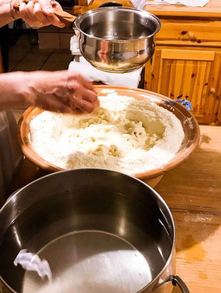 adding water to flour to make bread