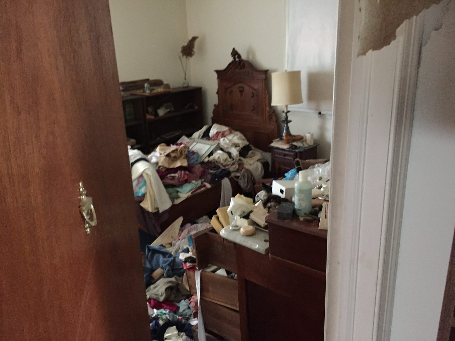 messy hoarder bedroom covered in stuff