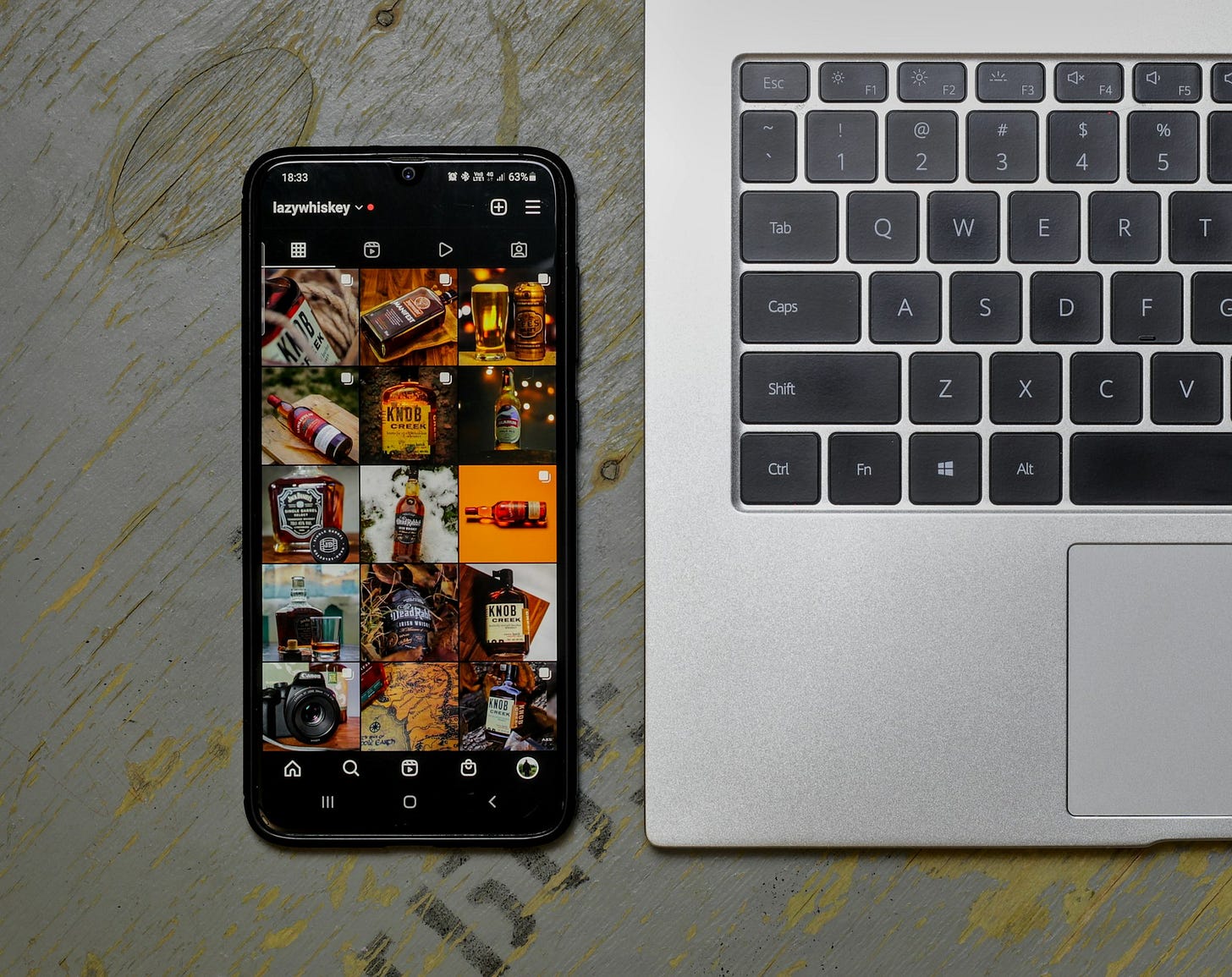 an open laptop computer sitting next to a cell phone an open laptop computer sitting next to a cell phone