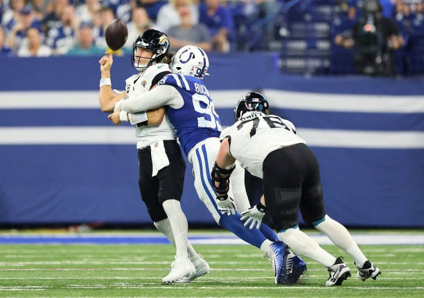 Trevor Lawrence of the Jacksonville Jaguars fumbles the ball as he is sacked by DeForest Buckner of the Indianapolis Colts in the third quarter at...