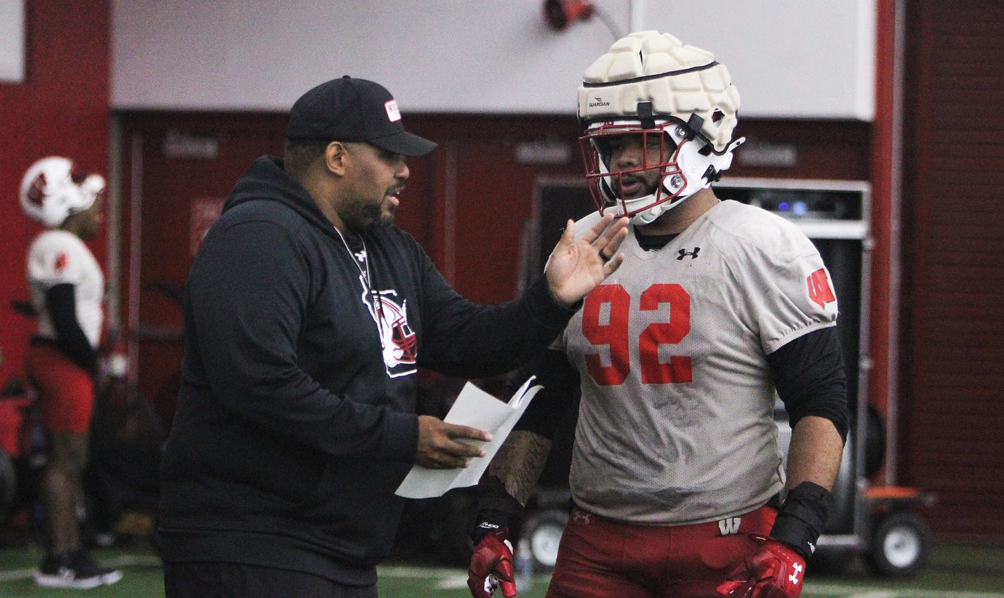 Wisconsin Badgers defensive line coach E.J. Whitlow talks with Curt Neal practice at the McClain Center