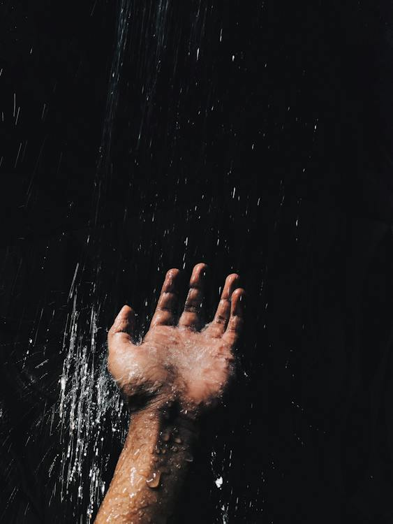 Free Person's Left Hand Catching Water Stock Photo