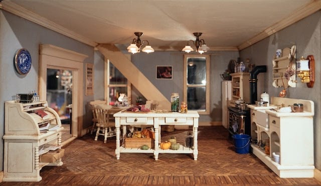 interior photo of a room in a dollhouse decorated like an antique farmhouse