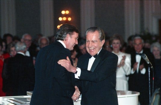 In this March 11, 1989, photo Donald Trump shakes hands with former President Richard Nixon at a tribute gala to Nellie Connally at the Westin Galleria ballroom in Houston, Texas. The letters between Trump and Nixon revealed for the first time in an exhibit that opens Thursday, Sept. 24, 2020, at the Richard Nixon Presidential Library & Museum, show the two men engaged in something of an exercise in mutual affirmation. The museum shared the letters exclusively with The Associated Press ahead of the exhibit’s opening. (Richard Carson/Houston Chronicle via AP)