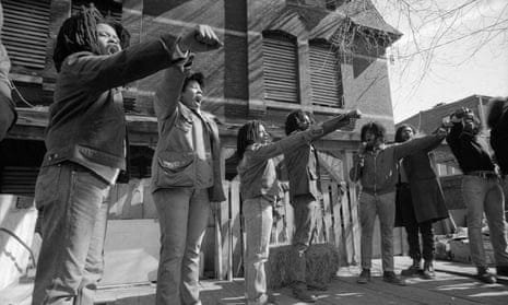 Members of Move show defiance to the police as they stand in front of their barricaded house in Philadelphia, Pennsylvania. Members of Move show defiance to the police as they stand in front of their barricaded house in Philadelphia, Pennsylvania.
