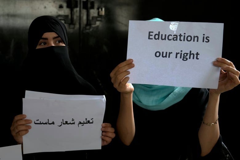 Afghan girls hold an illegal protest to demand the right to education in a private home in Kabul, Afghanistan on Aug. 2, 2022. For most teenage girls in Afghanistan, it’s been a year since they set foot in a classroom. With no sign the ruling Taliban will allow them back to school, some girls and parents are trying to find ways to keep education from stalling for a generation of young women.