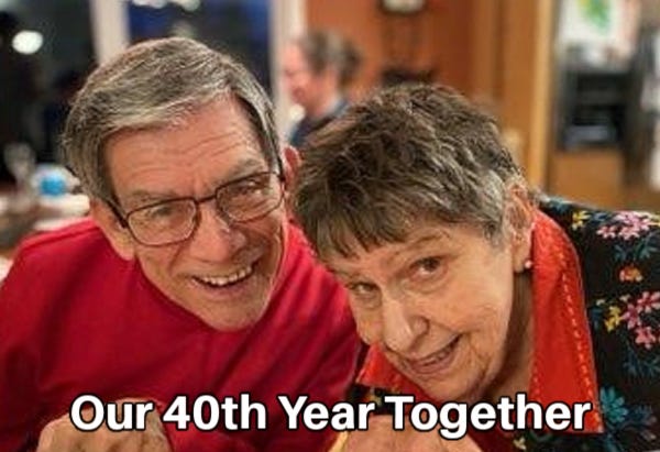 Portrait of Jim and Pam Hasse in 2023, both wearing red tops, during Thanksgiving dinner.