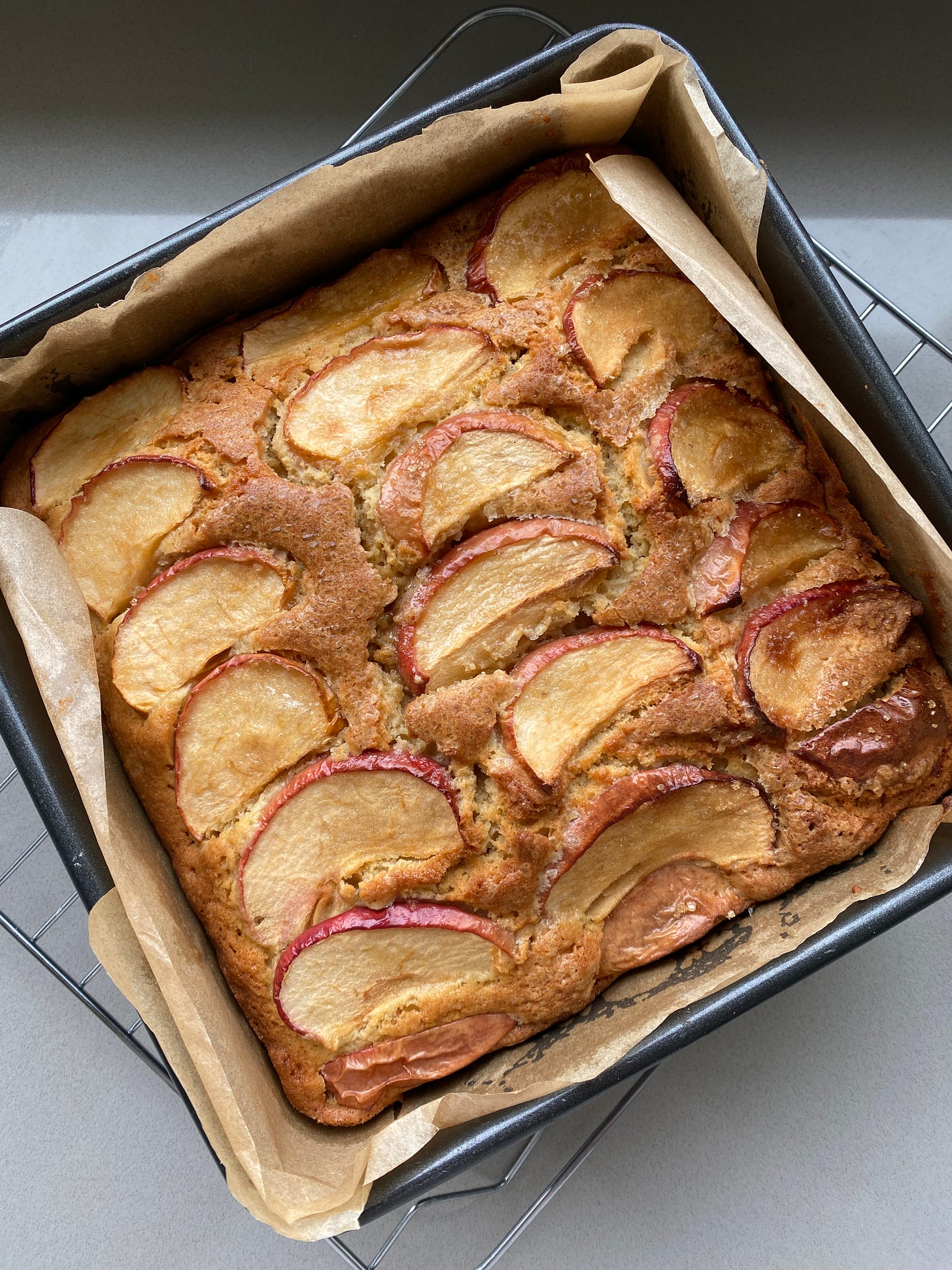 Baked Dorset Apple Cake with a slice cut out and placed onto a small plate.