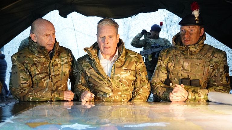 Sir Keir Starmer (centre) and John Healey (left) during their visit to meet British troops at the Tapa Nato base in Estonia. Picture date: Thursday December 21, 2023.