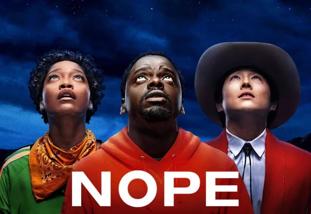 An image of Keke Palmer, Daniel Kaluuya, and Steve Yeun looking up at the Sky, the poster for Nope