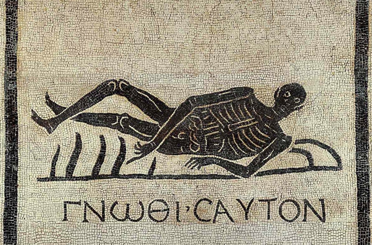  Black and tan stone mosaic of a skeleton reclining on what appears to be a bed of spikes; his legs are crossed somewhat delicately at the ankles. Below is the inscription ΓΝΩΘΙ Σ(Ε)ΑΥΤΟΝ.