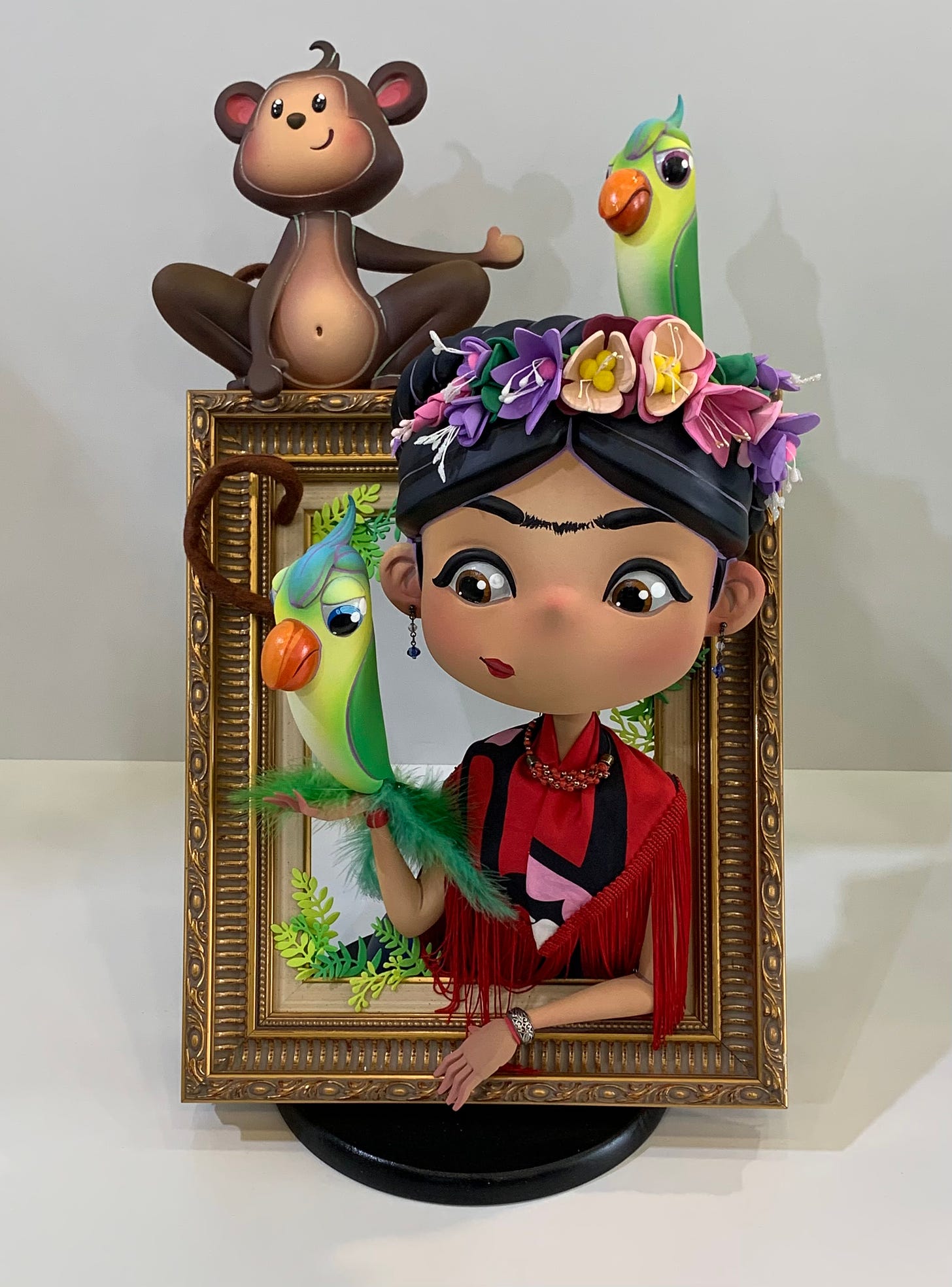 a cartoon version of Frieda Kahlo emerges from a frame 