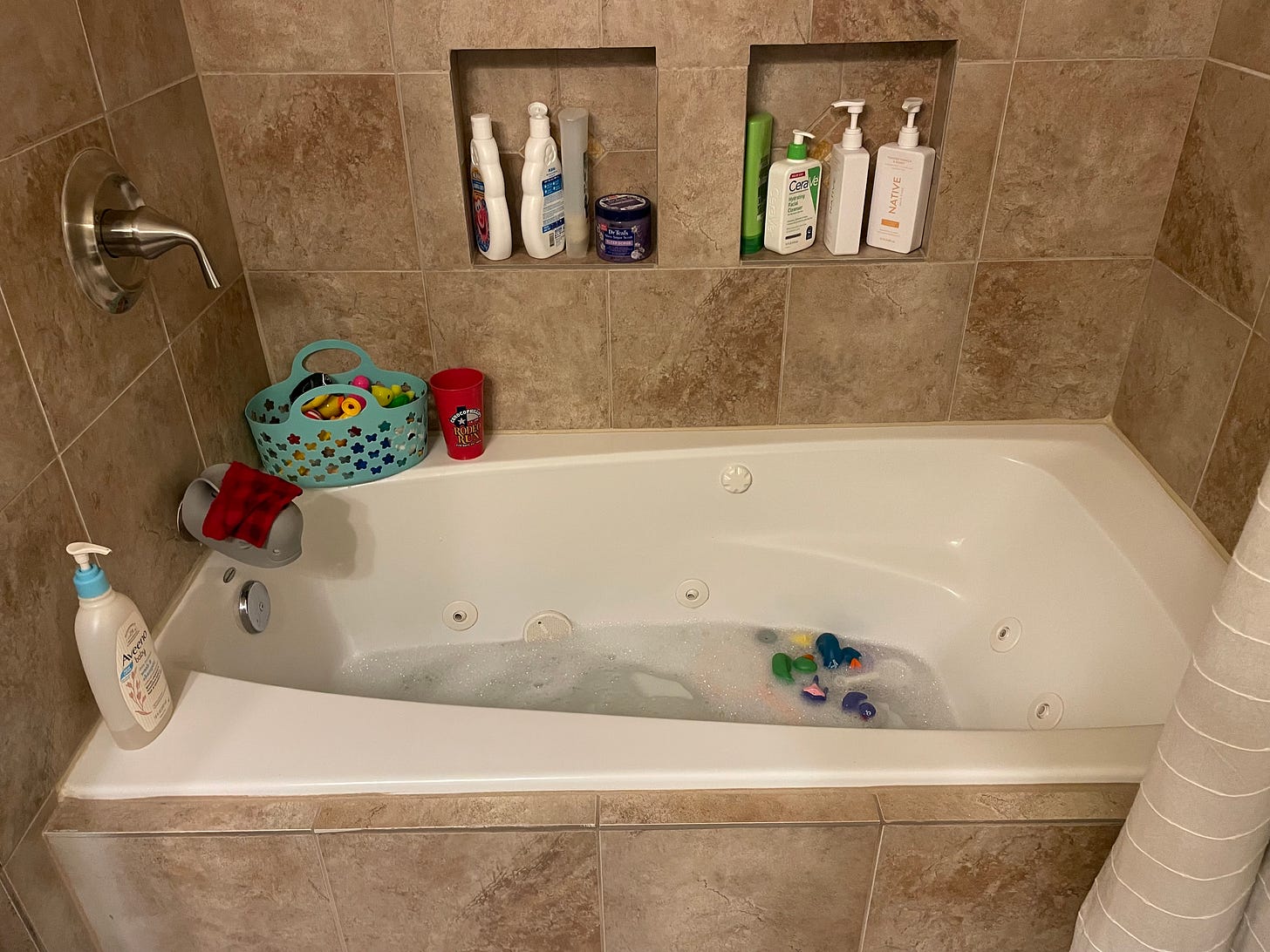 a bathtub filed with kids toys