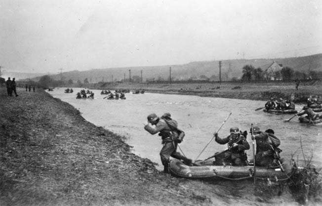 German troops use rubber rafts to cross a river somewhere in France. Lt. Col. Balck accompanied his men across the Meuse near Sedan where the first waves of German infantry took heavy casualities.