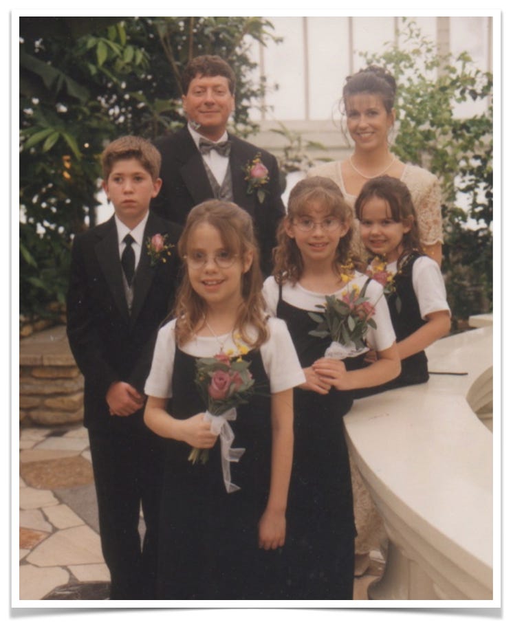 Wedding portrait of a blended family including a bride, groom and four children.